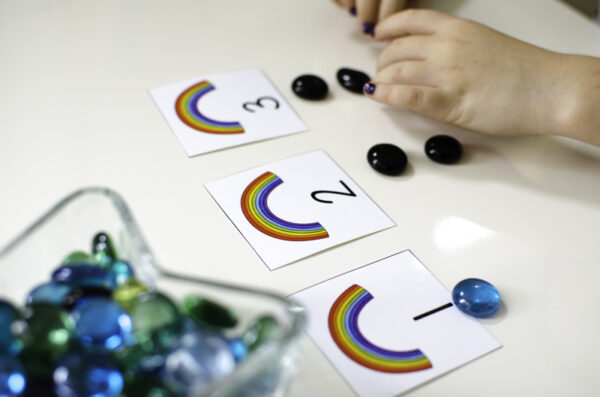 the numbers one, two, and three shown on rainbow counting cards