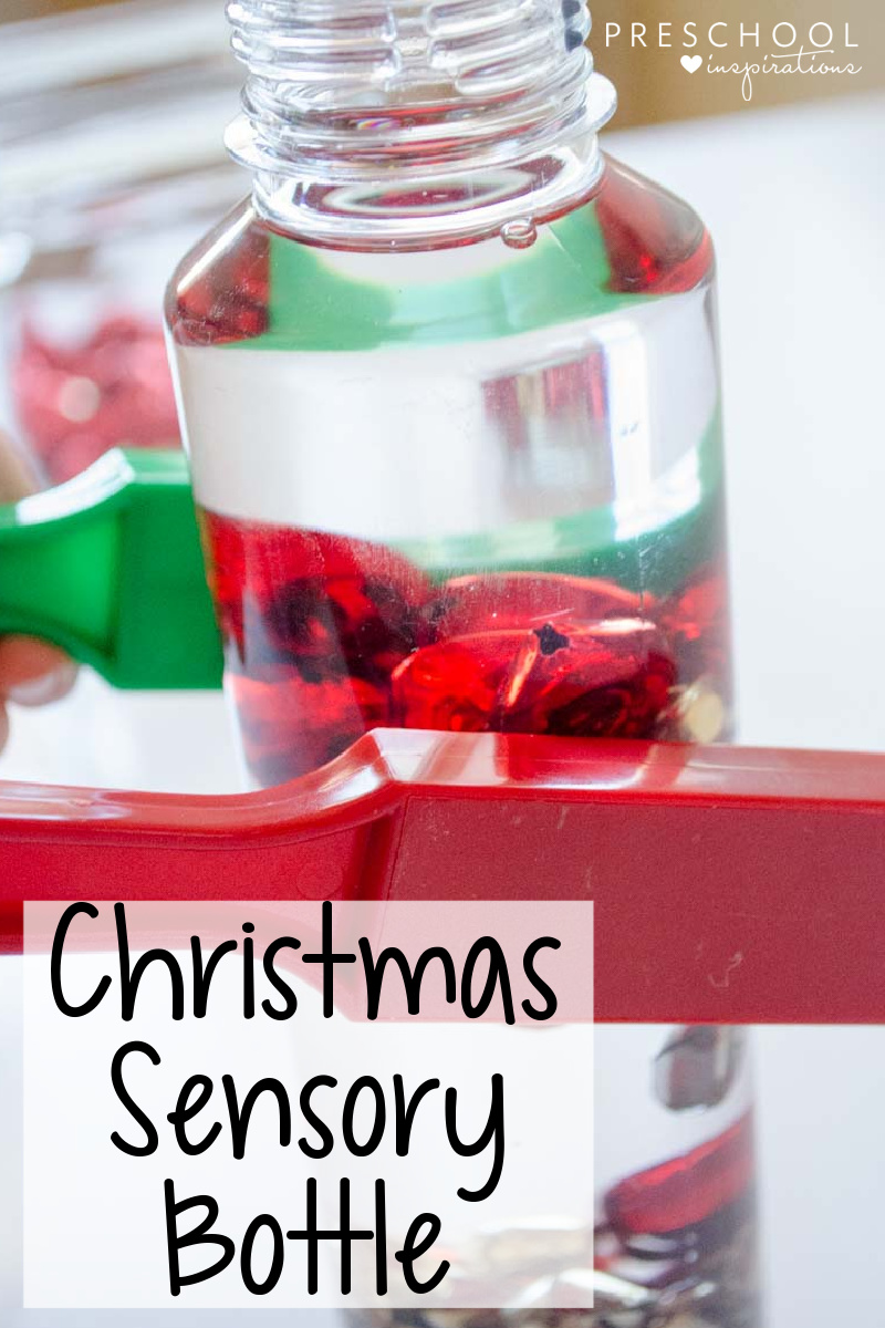 a magnetic wand on the side of a jingle bells sensory bottle with the text, 'Christmas sensory bottle'