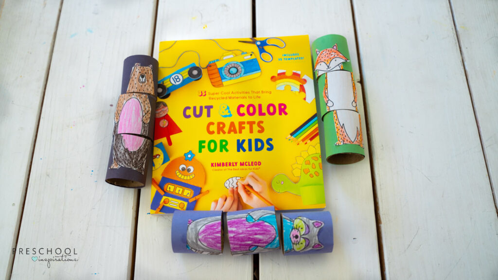"Cut and Color Crafts for Kids" book with animal puzzles all around it. 