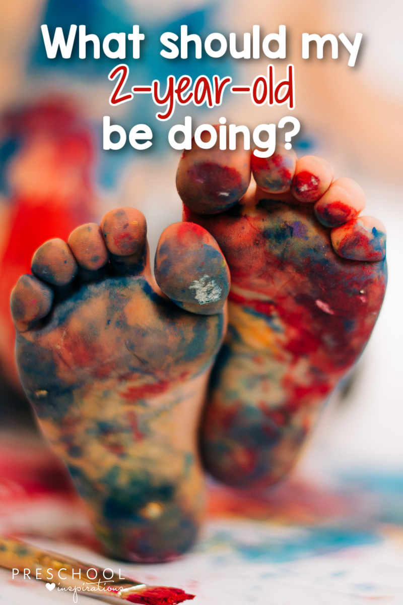 pinnable image of a toddler's feet covered in paint and the text 'what should my 2-year-old be doing?'