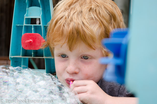 Let children make bubbles to their heart's content in this bubble blowing sensory table-6