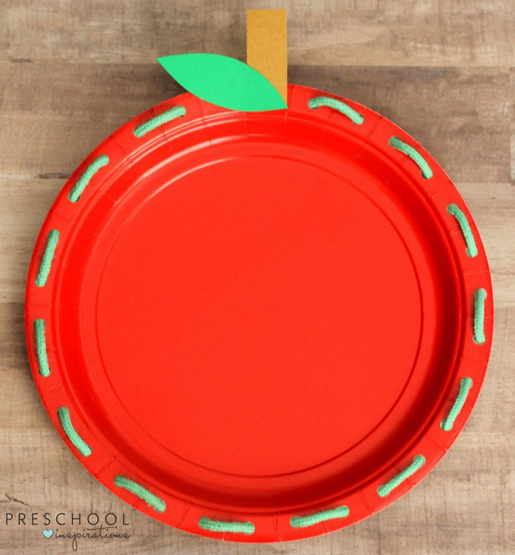 Work on fine motor skills with an apple paper plate lacing activity